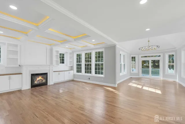 a view of an empty room with a fireplace and a window