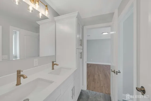 a bathroom with a sink and a mirror