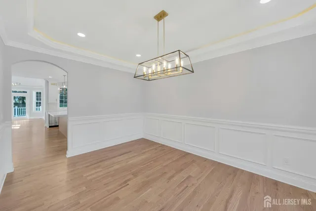 a view of a room with wooden floor and white walls