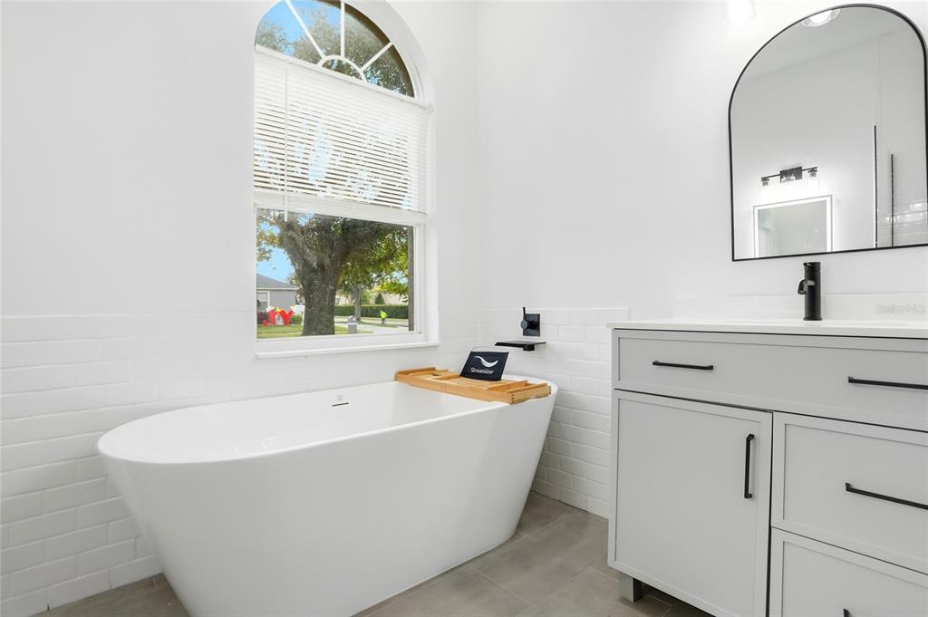 3345 Furlong Way Gotha, FL 34734 - Photo 18 of 34 a bathroom with a bathtub and a sink