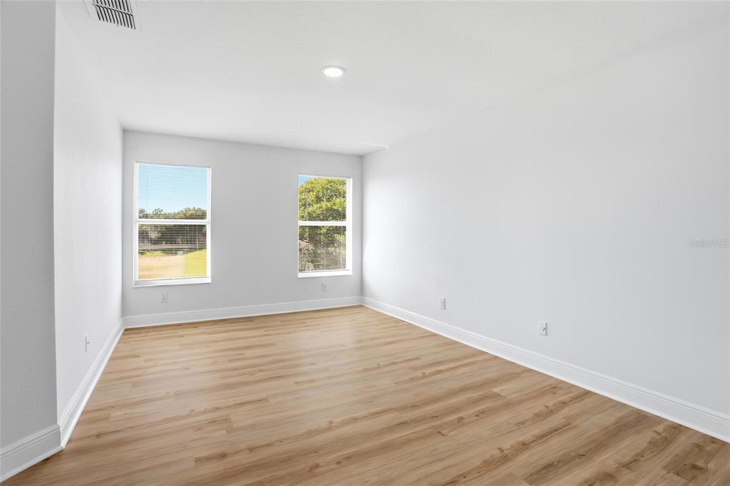 3345 Furlong Way Gotha, FL 34734 - Photo 23 of 34 an empty room with wooden floor and windows