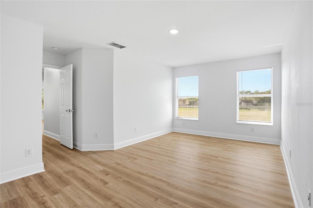 3345 Furlong Way Gotha, FL 34734 - Photo 24 of 34 an empty room with wooden floor and windows