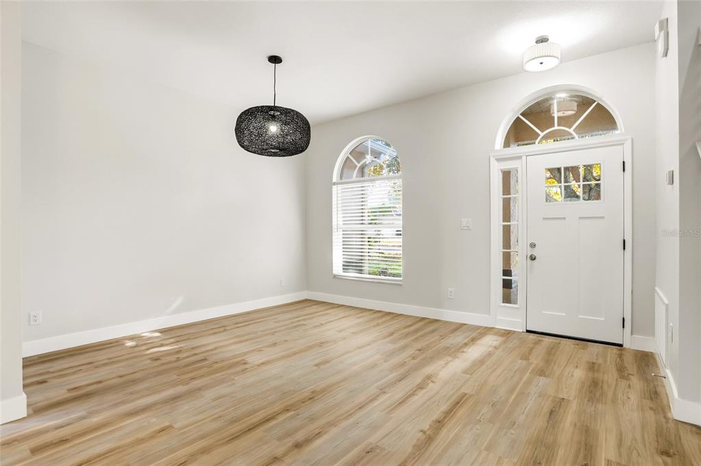 3345 Furlong Way Gotha, FL 34734 - Photo 4 of 34 an empty room with wooden floor cabinet and windows