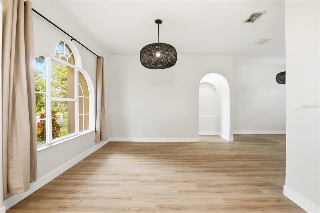 3345 Furlong Way Gotha, FL 34734 - Photo 6 of 34 a view of an empty room with a window and wooden floor