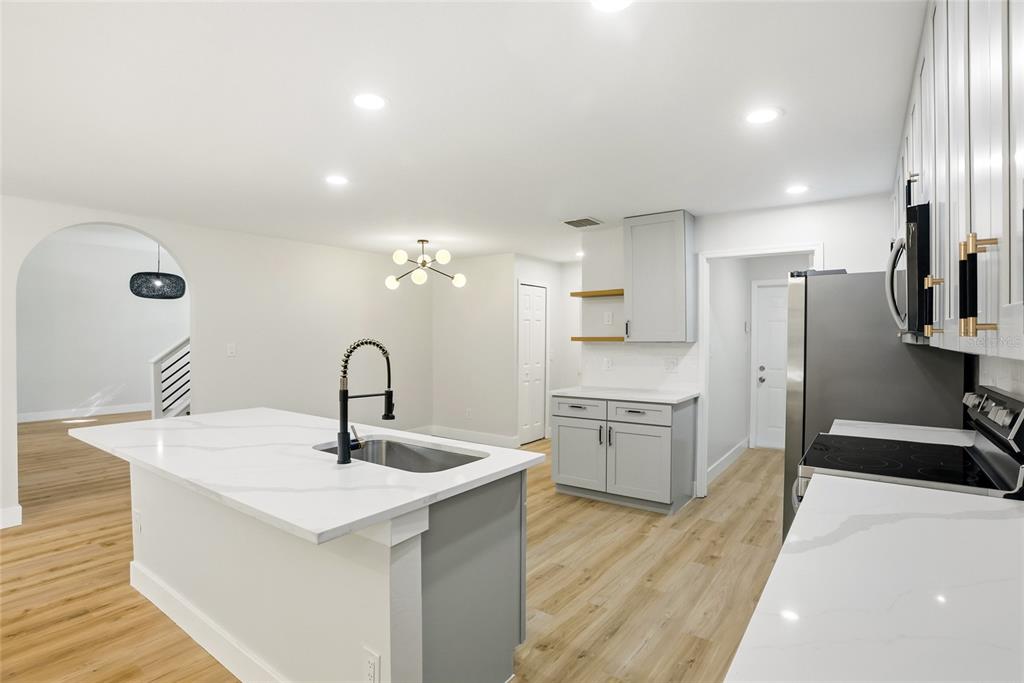 3345 Furlong Way Gotha, FL 34734 - Photo 10 of 34 a kitchen with a sink a stove a refrigerator and cabinets