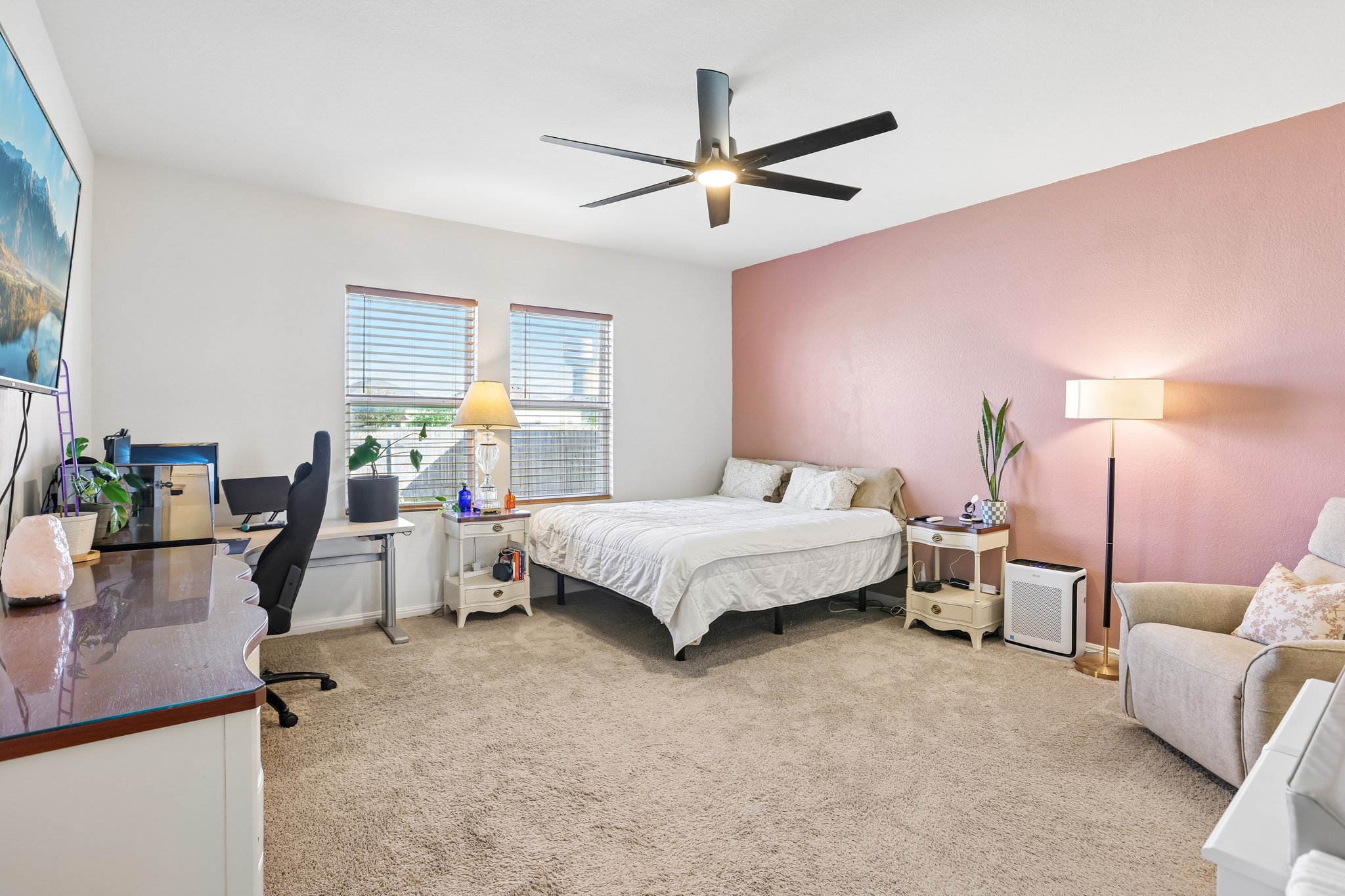 19105 Mike Mansfield Road Manor, TX 78653 - Photo 12 of 28 a bedroom with a bed and a chandelier