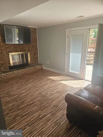 a view of empty room with window and fireplace