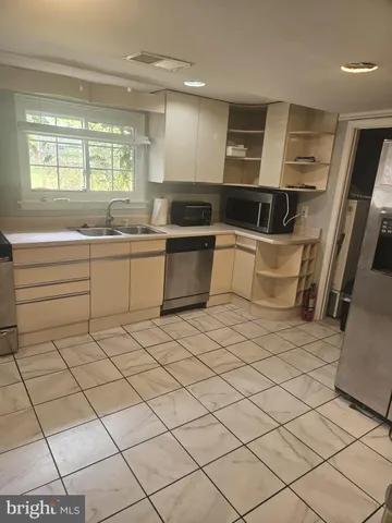 a kitchen with a sink and cabinets