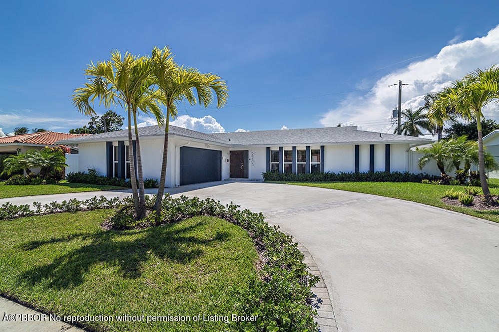 2285 Palm Road West Palm Beach, FL 33406 - Photo 1 of 27 a front view of a house with a garden and plants