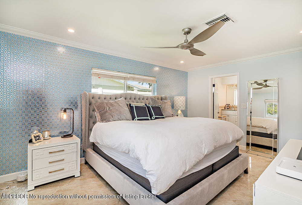 2285 Palm Road West Palm Beach, FL 33406 - Photo 12 of 27 a large bedroom with a bed and wooden floor
