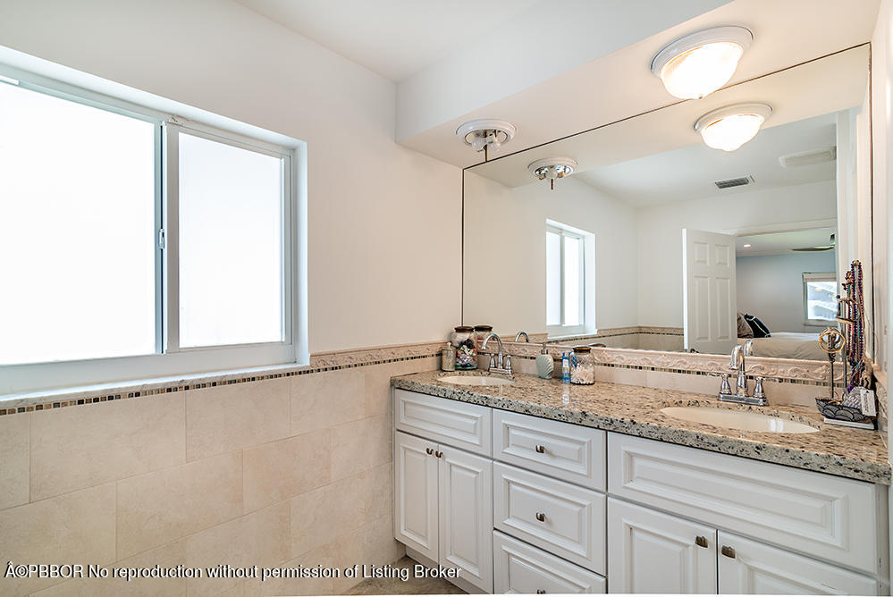 2285 Palm Road West Palm Beach, FL 33406 - Photo 13 of 27 a bathroom with a granite countertop sink and a mirror