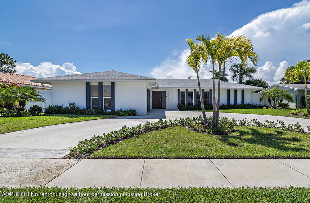 2285 Palm Road West Palm Beach, FL 33406 - Photo 3 of 27 a front view of a house with a garden and a yard