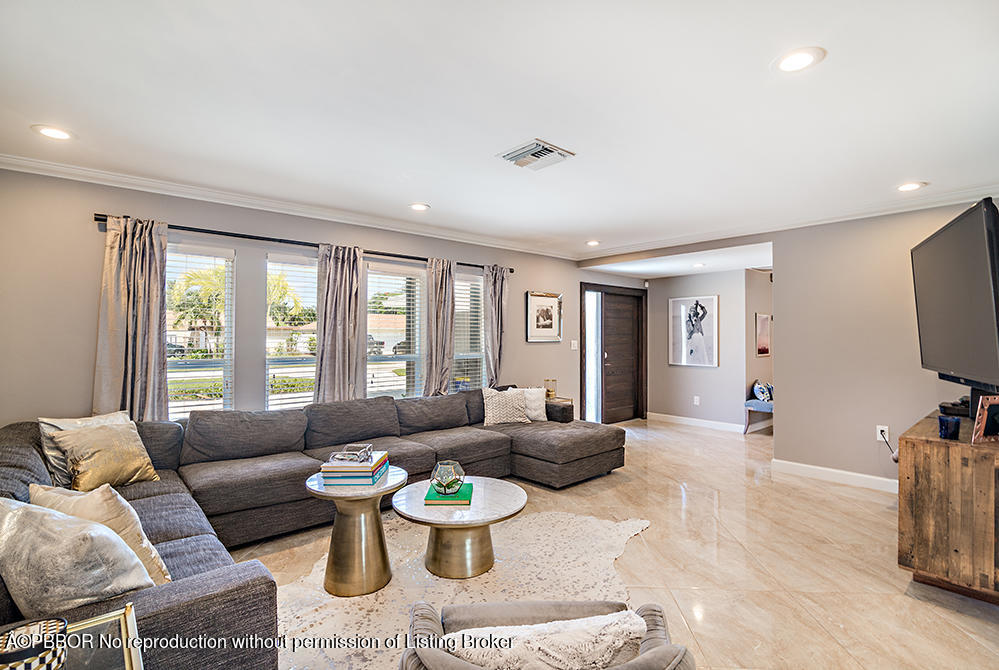 2285 Palm Road West Palm Beach, FL 33406 - Photo 5 of 27 a living room with furniture a window and a flat screen tv