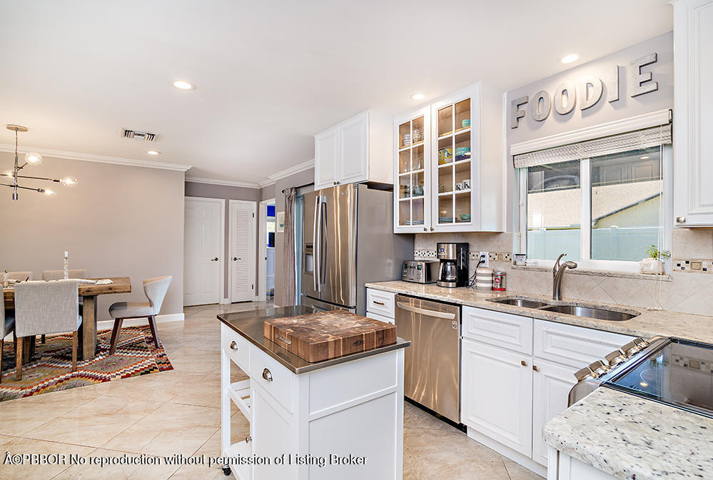 2285 Palm Road West Palm Beach, FL 33406 - Photo 10 of 27 a kitchen with a sink stove and cabinets