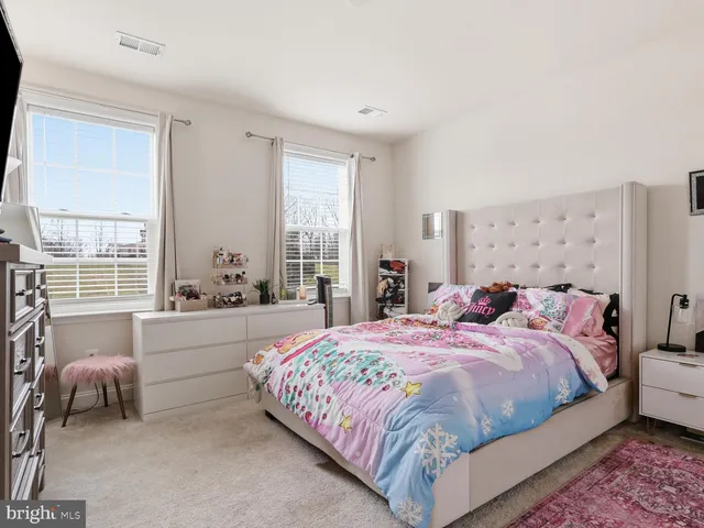 a bedroom with a large bed and a couch