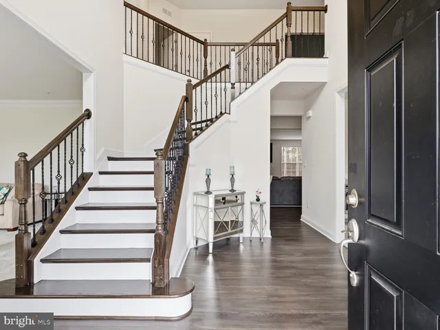 a view of entryway and hall with wooden floor