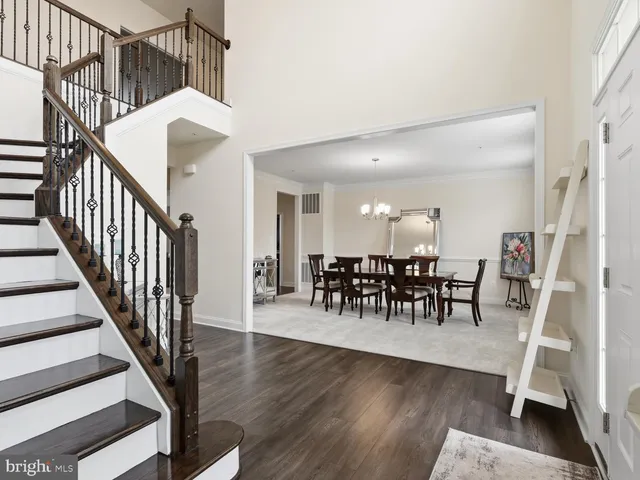 a dining room with furniture entryway and wooden floor