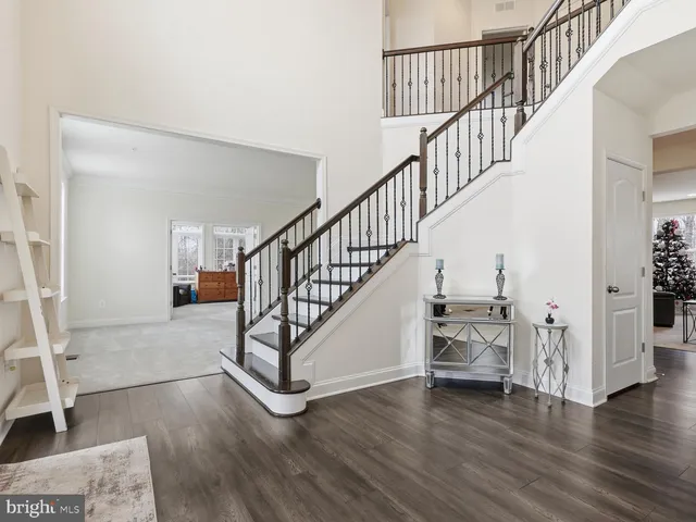 a view of staircase with wooden floor and a rug