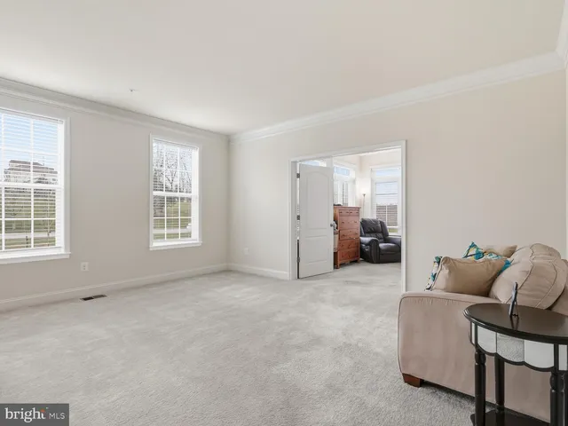 a living room with furniture and gym equipment
