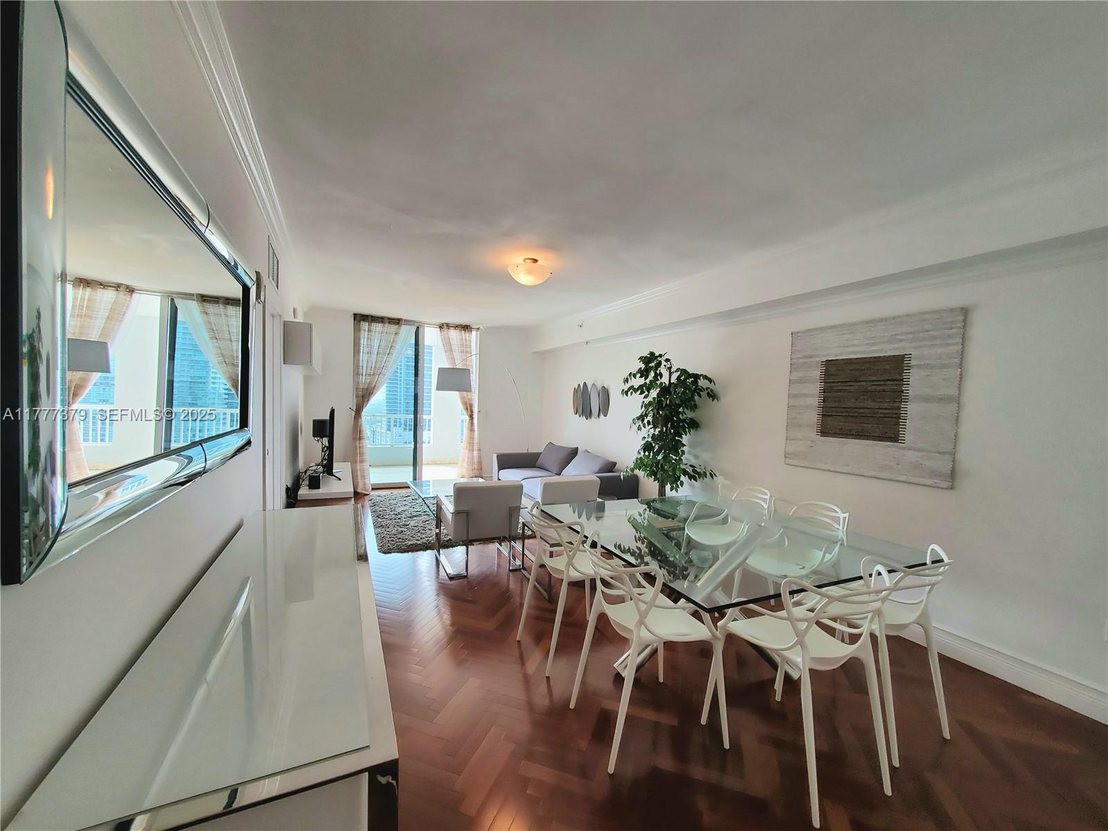 170 Southeast 14th Street, Unit 2705 Miami, FL 33131 - Photo 13 of 41 a view of a dining room with furniture window and wooden floor