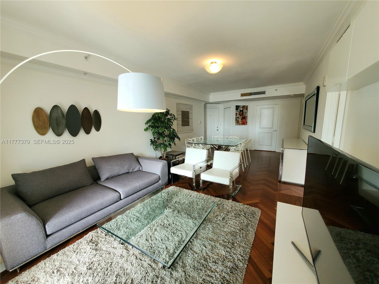170 Southeast 14th Street, Unit 2705 Miami, FL 33131 - Photo 15 of 41 a living room with furniture and a wooden floor