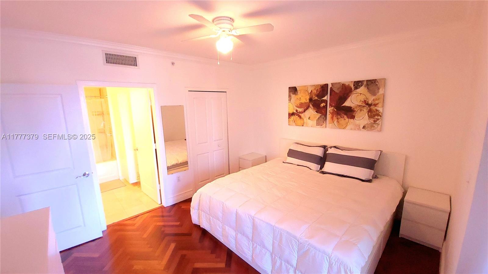 170 Southeast 14th Street, Unit 2705 Miami, FL 33131 - Photo 28 of 41 a bedroom with a bed and a painting on the wall