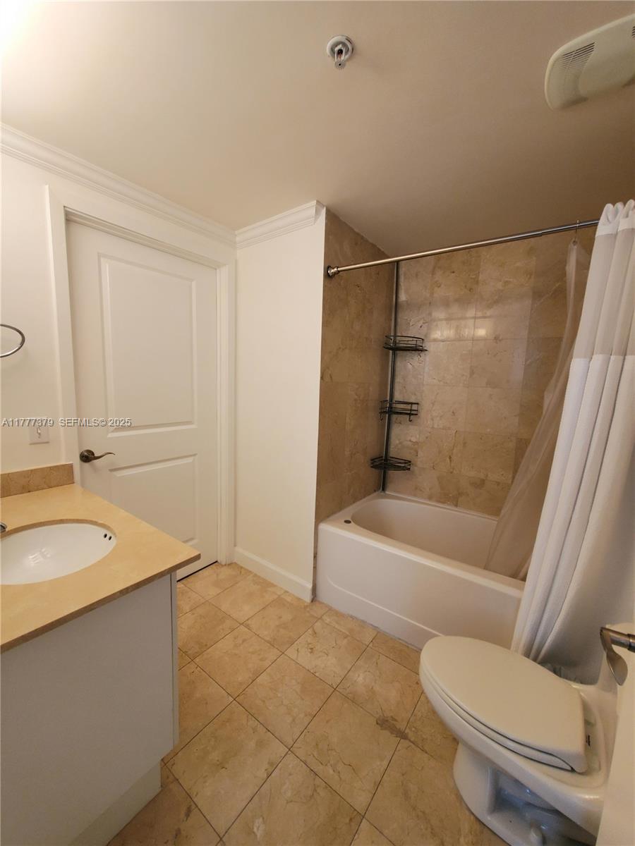 170 Southeast 14th Street, Unit 2705 Miami, FL 33131 - Photo 31 of 41 a bathroom with a granite countertop sink toilet and shower