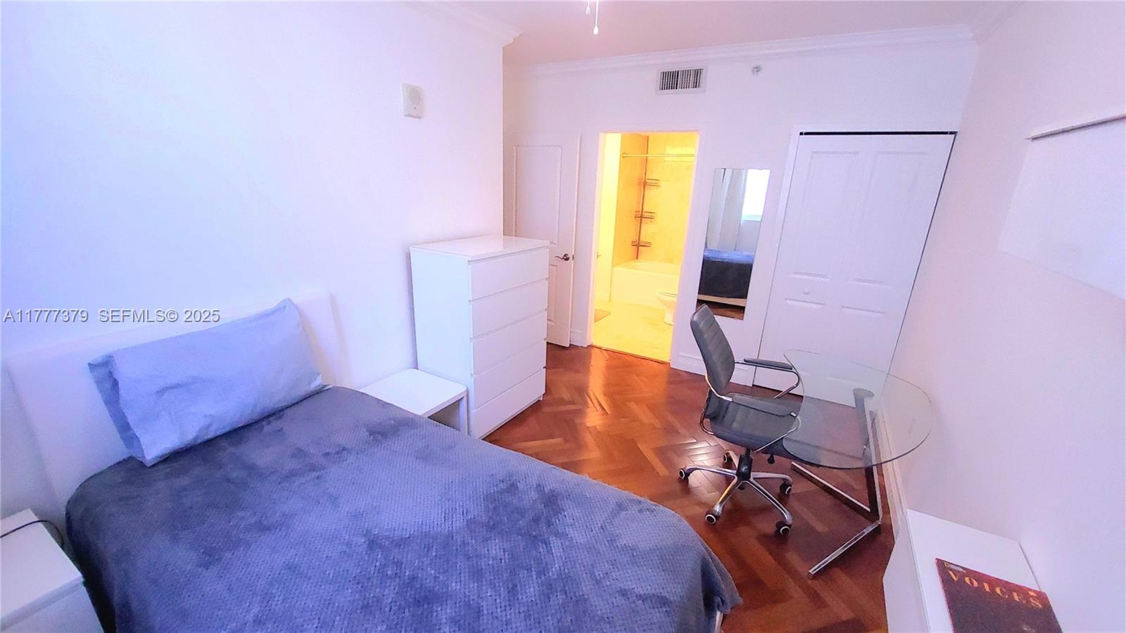 170 Southeast 14th Street, Unit 2705 Miami, FL 33131 - Photo 33 of 41 a bedroom with a bed and wooden floor