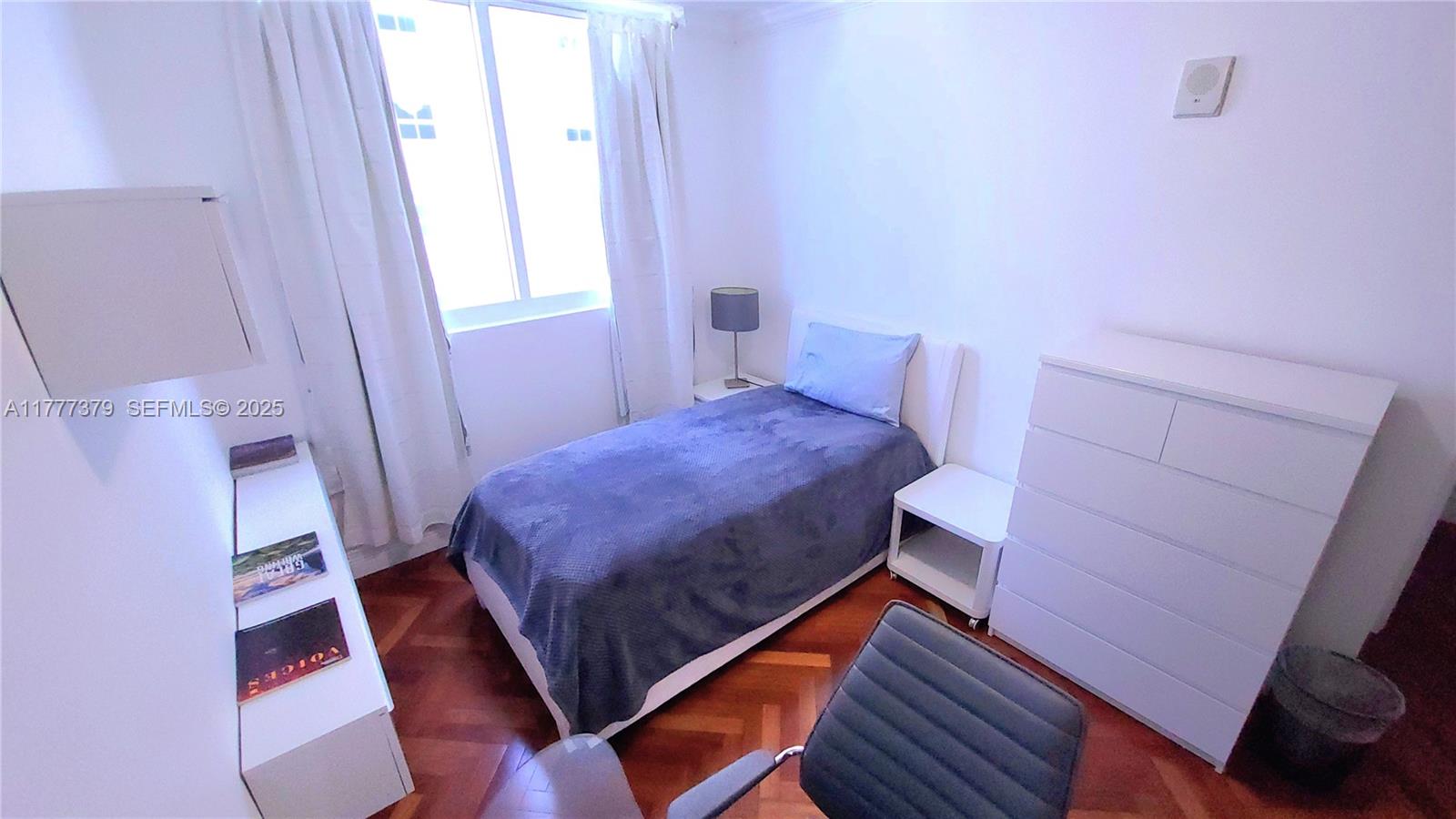 170 Southeast 14th Street, Unit 2705 Miami, FL 33131 - Photo 34 of 41 a bedroom with a bed and a mirror