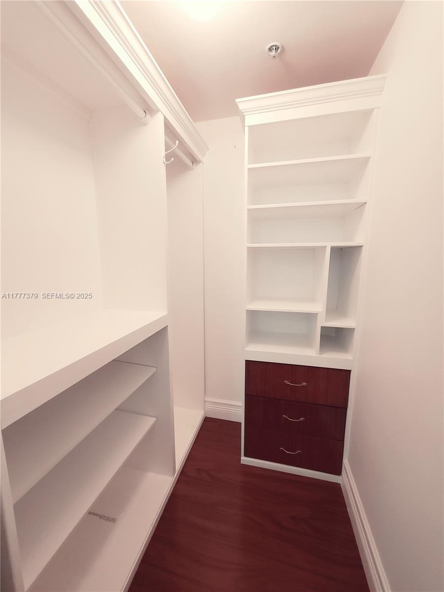 170 Southeast 14th Street, Unit 2705 Miami, FL 33131 - Photo 35 of 41 a view of walk in closet with empty racks