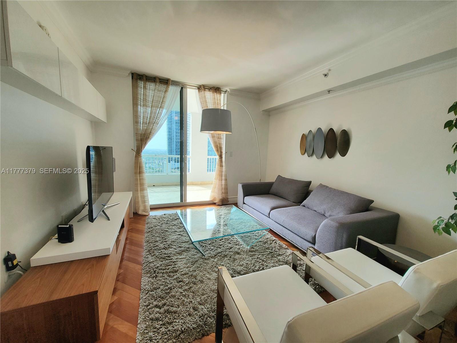 170 Southeast 14th Street, Unit 2705 Miami, FL 33131 - Photo 4 of 41 a living room with furniture and a rug