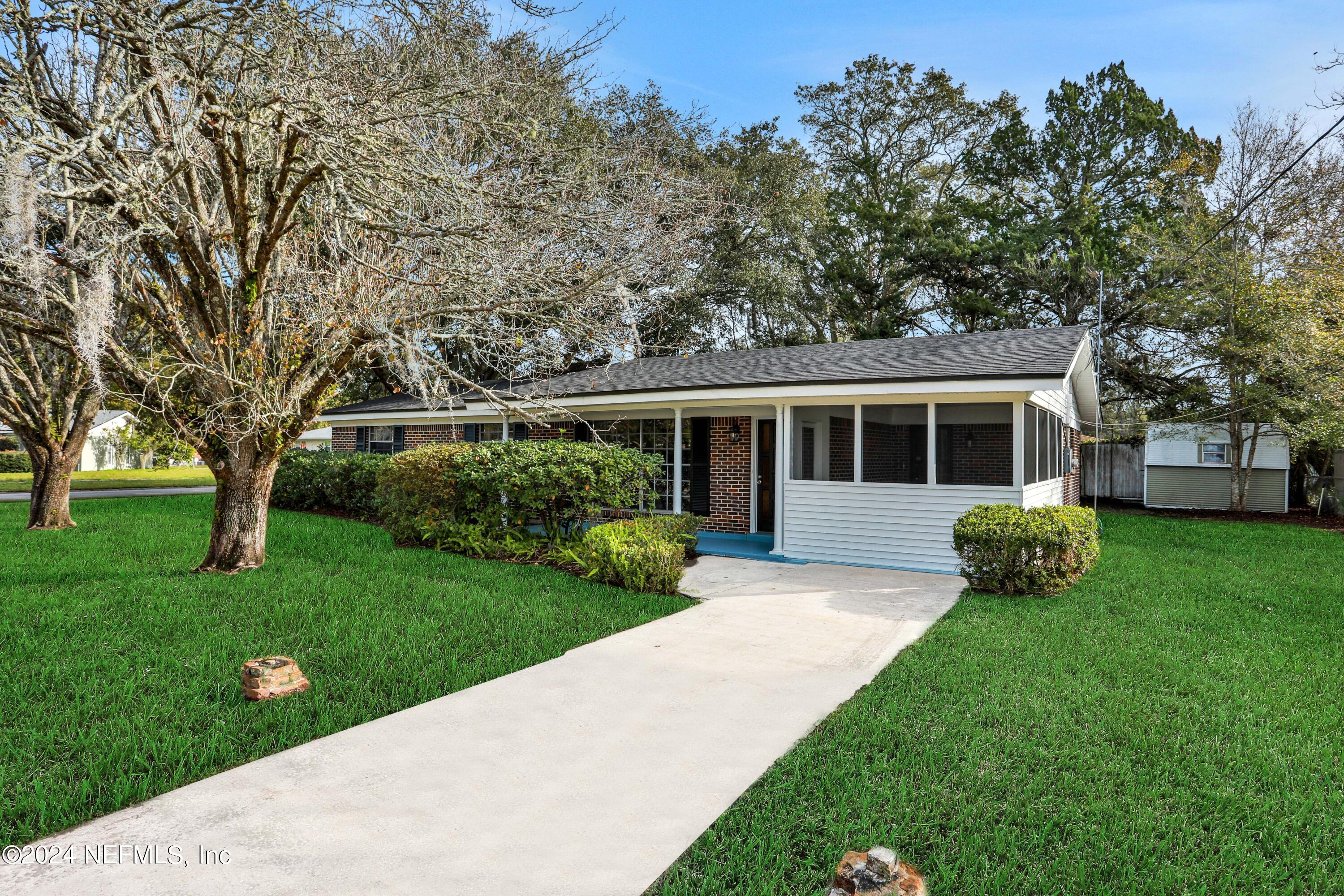 3211 Victoria Park Road Jacksonville, FL 32216 - Photo 2 of 25 a view of a house with a yard and tree s