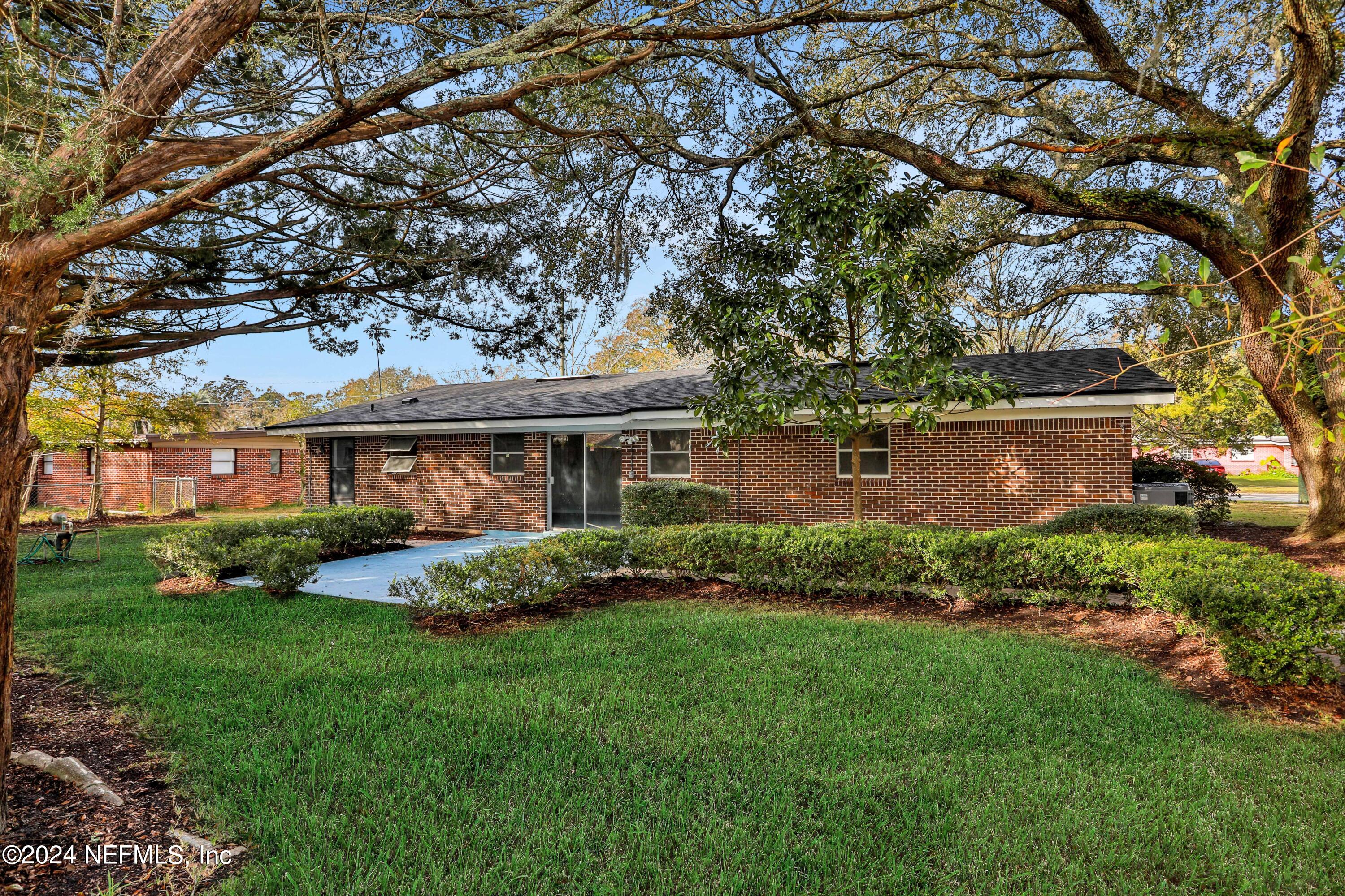 3211 Victoria Park Road Jacksonville, FL 32216 - Photo 24 of 25 a front view of a house with a garden and yard