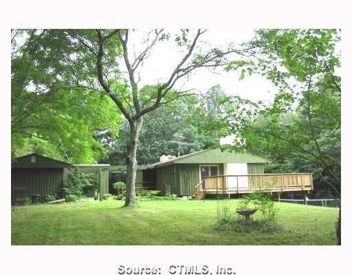 34 Dodd Road Mansfield, CT 06250 - Photo 1 of 1 a view of a big yard with a house in background