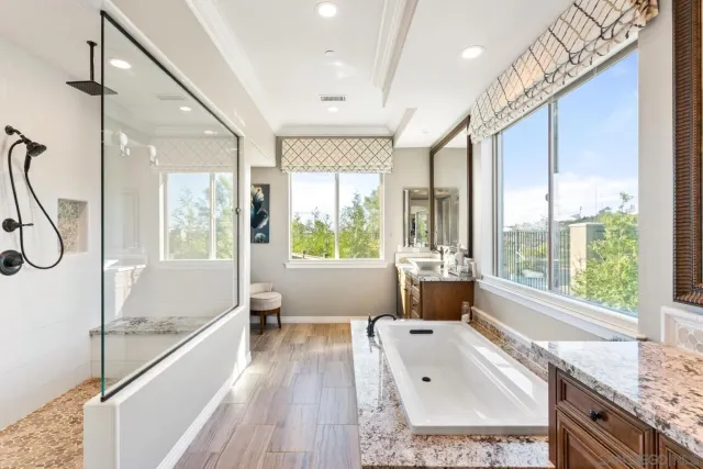 a front view of a house with a yard and potted plants