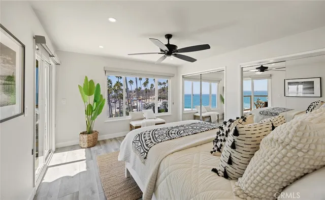 a bedroom with a bed and glass walk in closet