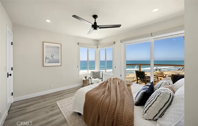 a bedroom with furniture and large windows