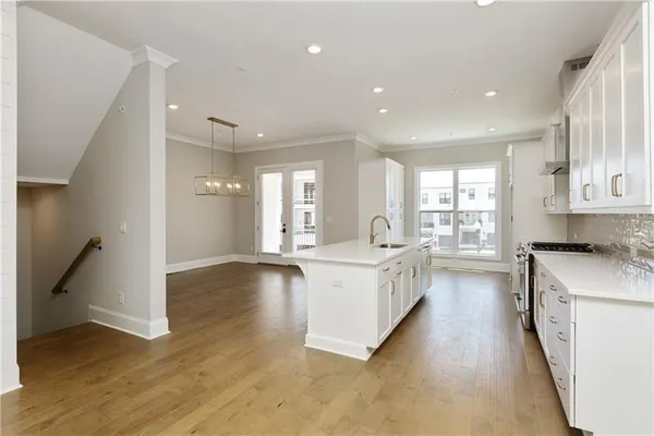 a large white kitchen with a large window