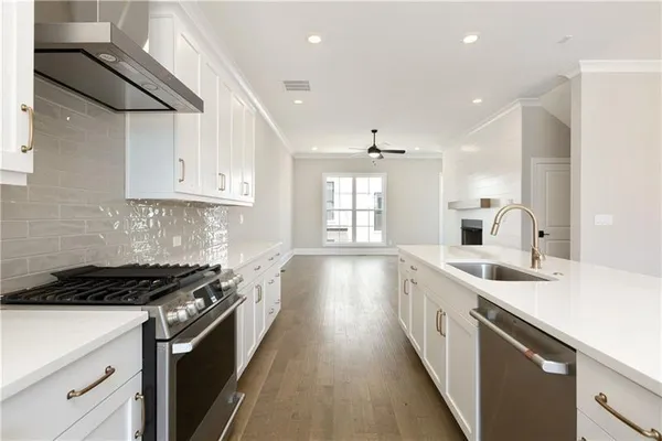 a kitchen with a sink stove and cabinets