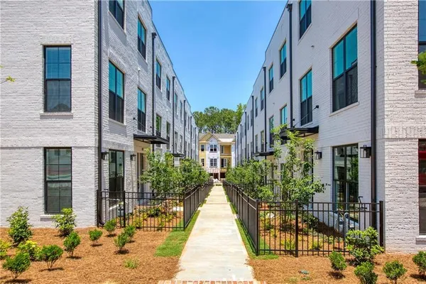 a view of a brick building next to a yard