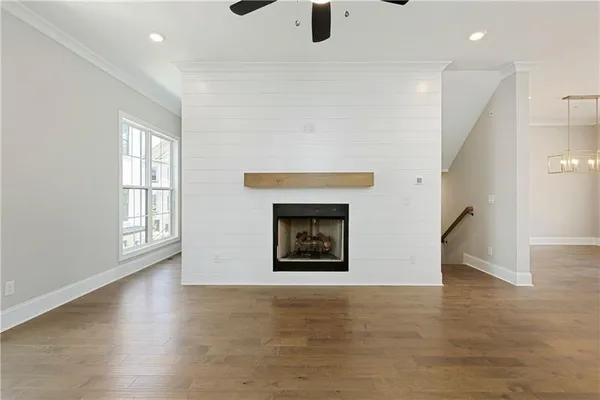an empty room with windows and fireplace