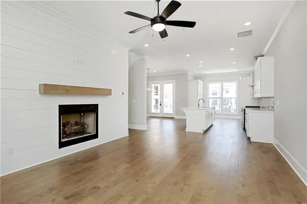 a view of a kitchen and an empty room with a fireplace