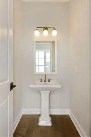 a bathroom with a sink a toilet and mirror