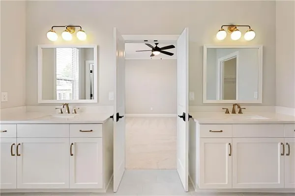 a bathroom with a double vanity sink and mirror