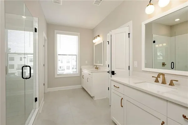 a bathroom with double vanity sinks double vanity and shower