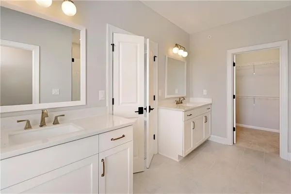 a bathroom with a double vanity sink mirror and