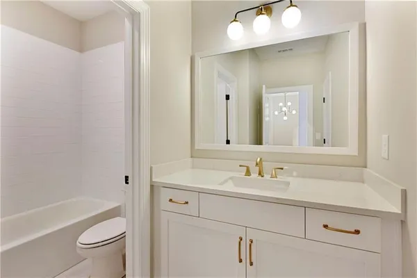 a bathroom with a sink a toilet a shower and a mirror