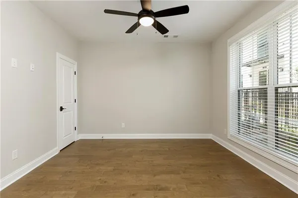 wooden floor in an empty room with a window
