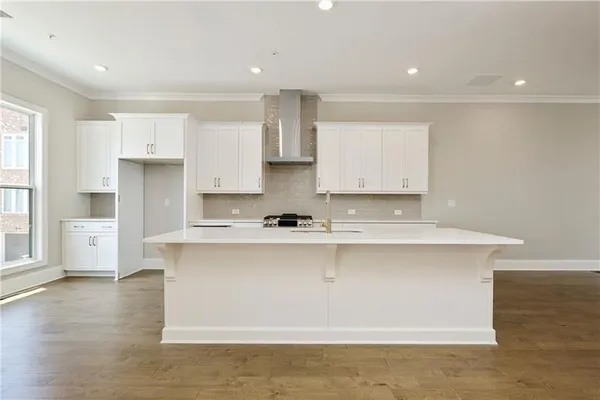 a kitchen with stainless steel appliances granite countertop a sink a stove and a refrigerator