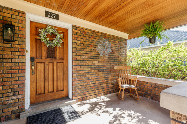 227 West 200 North Logan, UT 84321 - Photo 8 of 44 Inviting front porch featuring a paneled wood-finish door with decorative hardware
